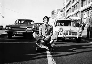 Derek Nimmo actor in Brighton riding a toy car dbase msi Derek Nimmo actor in Brighton riding a toy car dbase msi