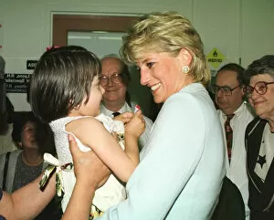 Images Dated 5th June 1996: Diana, Princess of Wales, smiles as she holds a young girl at Cook County Hospital