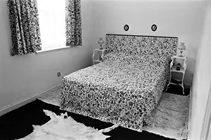 A display of a modern bedroom, with matching curtains, bedspread and headboard A display of a modern bedroom, with matching curtains, bedspread and headboard