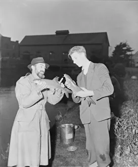 DM Anglers R Lalley B Venables Men holding and comparing fish DM Anglers R Lalley B Venables Men holding and comparing fish