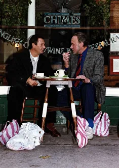 Images Dated 7th November 1990: Don Henderson Actor & Michael Elphick actor sitting at pavement cafe table with shopping