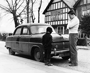 Donald Sinden and son Jeremy inspect their very dusty and grimy Consul Donald Sinden and son Jeremy inspect their very dusty and grimy Consul