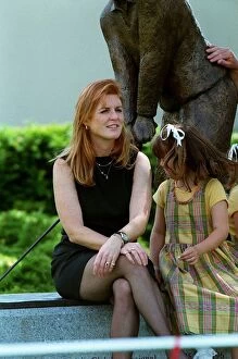 Images Dated 21st July 1998: Duchess Of York July 98 Sitting on wall at a golf tournament with her daughter