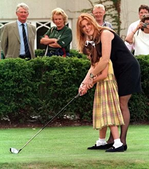 Images Dated 20th July 1998: The Duchess of York teaches her daughter Princess Eugenie golf during the charity