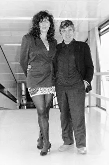 Images Dated 6th June 1991: Dudley Moore Actor with wife Brogan Lane leaving Heathrow airport for Geneva