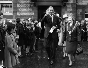 The Duke of Edinburgh walks through the lines of flag waving pupils at Kitchener Road The Duke of Edinburgh walks through the lines of flag waving pupils at Kitchener Road