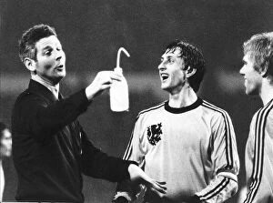 Dutch footballer Johan Cruyff shares a joke with the referee during the England v Holland
