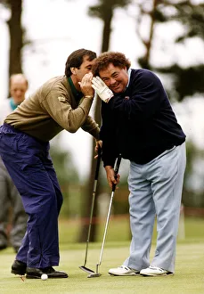 Eddie Little Comedian listens as Sevvy Ballesteros Golf whispers in his ear at a Pro Eddie Little Comedian listens as Sevvy Ballesteros Golf whispers in his ear at a Pro