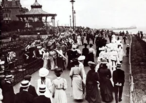 Edwardian Ladies and Gentleman walk up and down the promenade of an unnamed English South Edwardian Ladies and Gentleman walk up and down the promenade of an unnamed English South