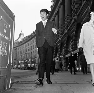 Elated comedian Jimmy Tarbuck walking along Regent Street Elated comedian Jimmy Tarbuck walking along Regent Street