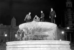 Election night scene in Trafalgar Square. Revellers celebrating in the fountains after Election night scene in Trafalgar Square. Revellers celebrating in the fountains after