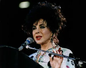 Images Dated 21st April 1992: Elizabeth Taylor Actress At Freddy Mercury Aids Concert talking into mike