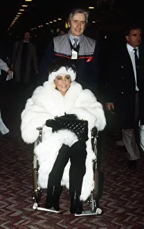 Elizabeth Taylor Jan 1987 wearing White Fur coat in wheelchair at Heathrow Airport Elizabeth Taylor Jan 1987 wearing White Fur coat in wheelchair at Heathrow Airport