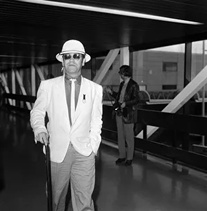 Elton John at Heathrow Airport. 6th August 1983 Elton John at Heathrow Airport. 6th August 1983