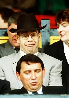Images Dated 29th April 1991: Elton John Singer & Chairman of Watford FC pulls a funny face at Manager Graham Taylor