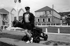Elton John Singer Songwriter standing beside a cannon on the West Indies Island of Elton John Singer Songwriter standing beside a cannon on the West Indies Island of