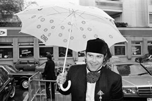 Elton John standing in the rain. He is in Montreux to perform at the Montreux Pop