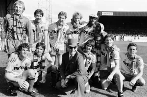 Images Dated 14th May 1983: Elton John and the Watford side pose for the photographers after their match against