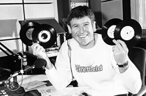 Images Dated 1st January 1988: Emlyn Hughes of Liverpool January 1988 holding up records ashe does his DJ bit at
