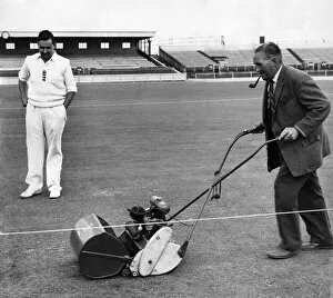 England batsman Colin Cowdrey watches groundsman Bert Flack add the finishing touches to