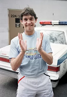Images Dated 15th May 1986: England football star Gary Lineker, is handcuffed during a visit to a police station in