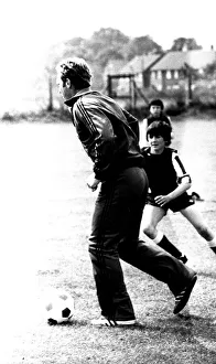 Images Dated 23rd July 1980: Former England footballer Bobby Moore coaches children at the Coral sponsored Bobby Moore