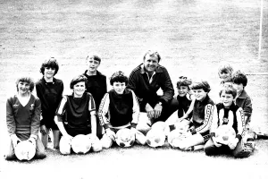 Images Dated 23rd July 1980: Former England footballer Bobby Moore coaches children at the Coral sponsored Bobby Moore