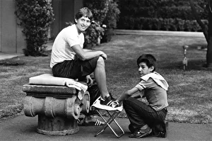 England footballer Gary Lineker has his boots cleaned by a shoe shine boy at the team England footballer Gary Lineker has his boots cleaned by a shoe shine boy at the team