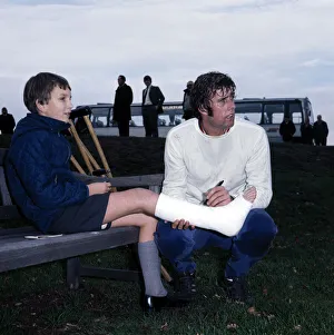 Images Dated 24th November 1970: England footballer Geoff Hurst signs an autograph for a young fan in plaster caste during