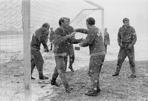 Core61 Gallery: England footballer Jimmy Greaves laughs as he walks out the goal during a snow covered
