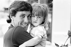 England footballer Kenny Sansom with his young daughter at the team base during the 1982 England footballer Kenny Sansom with his young daughter at the team base during the 1982