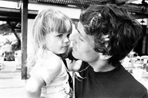 Images Dated 16th June 1982: England footballer Kenny Sansom with his young daughter at the team base during the 1982