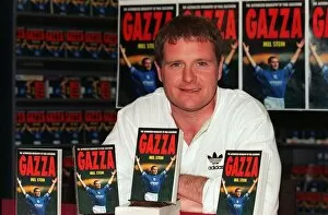Images Dated 8th May 1996: England footballer Paul Gascoigne holds up a copy of his latest autobiography at a book
