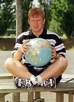 Images Dated 19th June 1998: England footballer Paul Scholes point out Romania on Globe