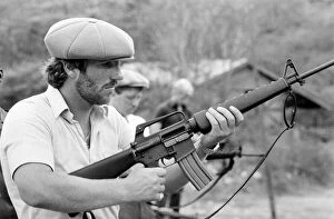 Images Dated 26th May 1981: England in West Indies 1981. Ian Botham with the England team trying out some guns