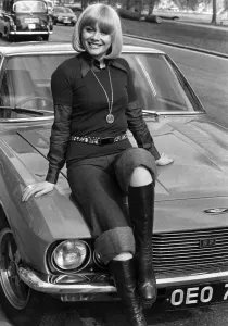 Entertainment actress Anne Aston sitting on the bonnet of her car. May 1976 P017209 Entertainment actress Anne Aston sitting on the bonnet of her car. May 1976 P017209