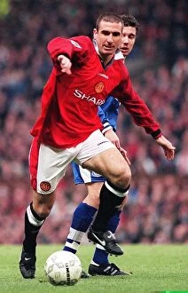 Images Dated 30th November 1996: Eric Cantona fends off a Leicester defender during their match at Old Trafford