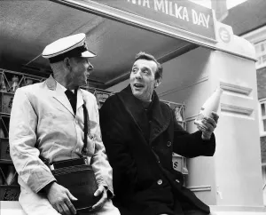 Occupation M Gallery: Eric Sykes Comedy Actor Comedian being shown by his milkman Harry Smith how its done