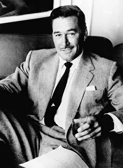 Images Dated 1st September 1977: Errol Flynn Actor- September 1977 sitting in a chair with a glass in his