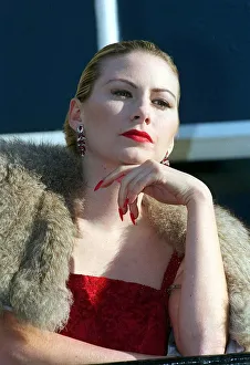 Evita Fashion Model on balcony wearing fur cape red dress long nails with red nail Evita Fashion Model on balcony wearing fur cape red dress long nails with red nail