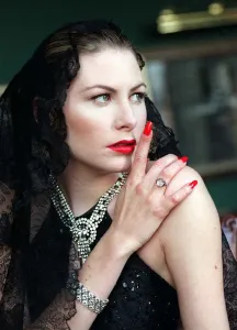 Evita Fashion Model wearing black mantilla and off the shoulder evening dress Evita Fashion Model wearing black mantilla and off the shoulder evening dress