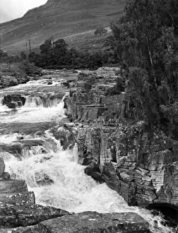 Falls of Glascarnoch River in Ross and Cromarty. Visitors watch salmon leaping the falls Falls of Glascarnoch River in Ross and Cromarty. Visitors watch salmon leaping the falls