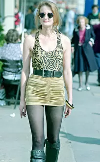 Images Dated 5th April 2005: Fashion 1990s Woman walking down the street wearing a mini skirt with a leotard