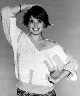 Fashion Knitting February 1986 Model wearing V neck pullover posing with one hand Fashion Knitting February 1986 Model wearing V neck pullover posing with one hand