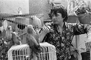 Images Dated 8th July 1974: Fashion photographer David Bailey pictured at home with some of his 40 parrots