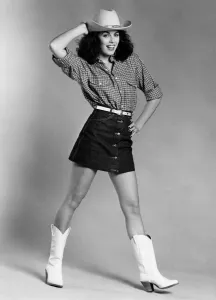 Fashion - Skirts. Model wears cowboy hat, checked shirt Fashion - Skirts. Model wears cowboy hat, checked shirt