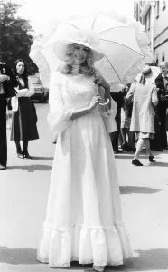 Fashionable racegoer with parasol at Royal Ascot in 1977 Seventies fashion Fashionable racegoer with parasol at Royal Ascot in 1977 Seventies fashion