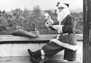 Father Christmas having a well earned cup of tea on a roof top, Teesside