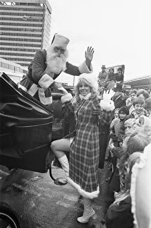 Images Dated 11th November 1970: Father Christmas seen here helping his assistant into a horse drawn carriage after