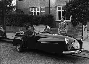 Related Images Collection: A father takes his son for a ride in his new convertible Bond mini car. Circa 1950